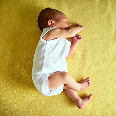 Buy stock photo Sleeping, cute and above of baby on yellow background for child development, wellness and growth. Adorable, blanket and newborn resting, tired and nap for childhood, dreaming and comfort in nursery