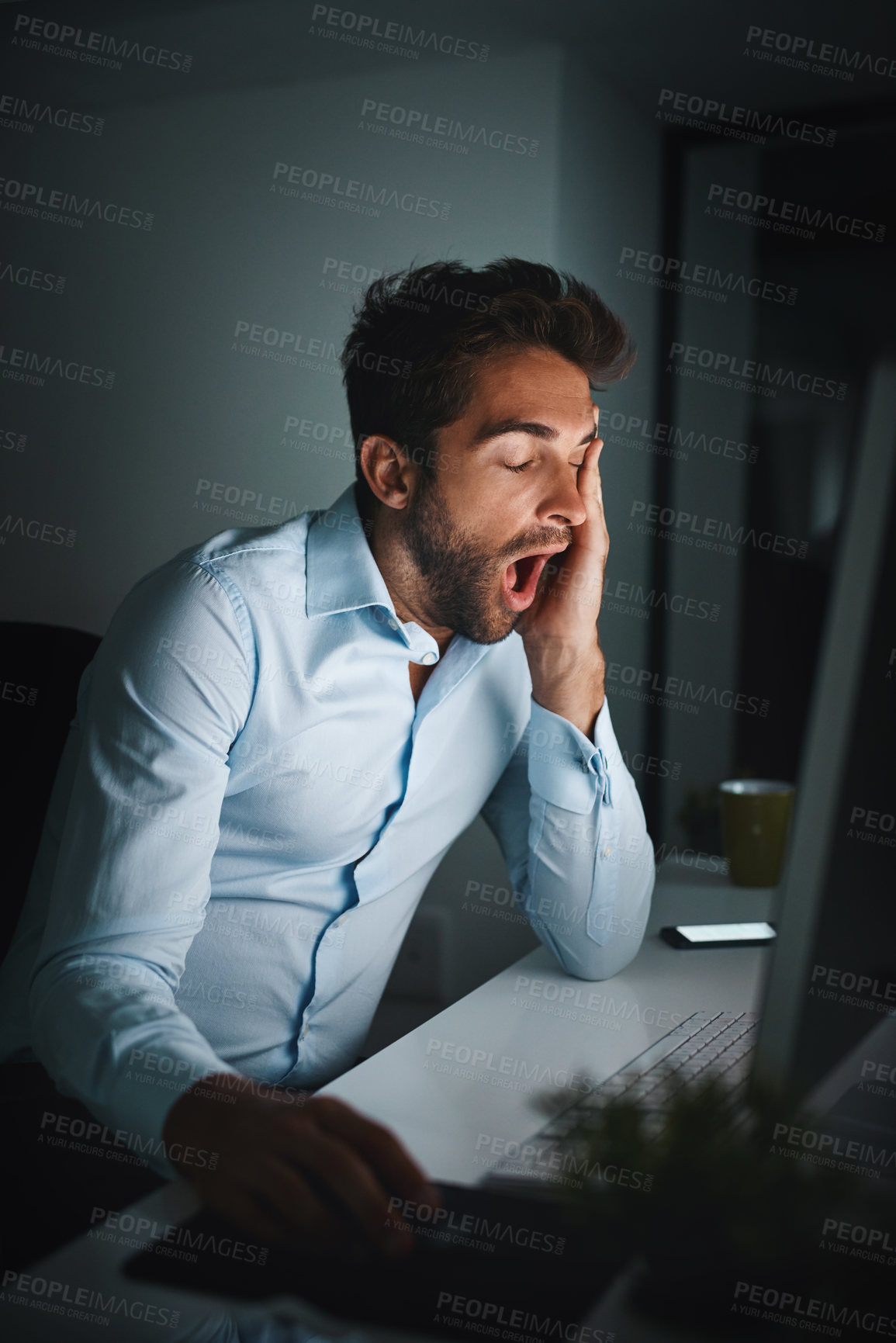 Buy stock photo Man, tired and yawning in office with computer for coding, programming and software development at night. Business fatigue, late or night for information technology and engineer with burnout in dark