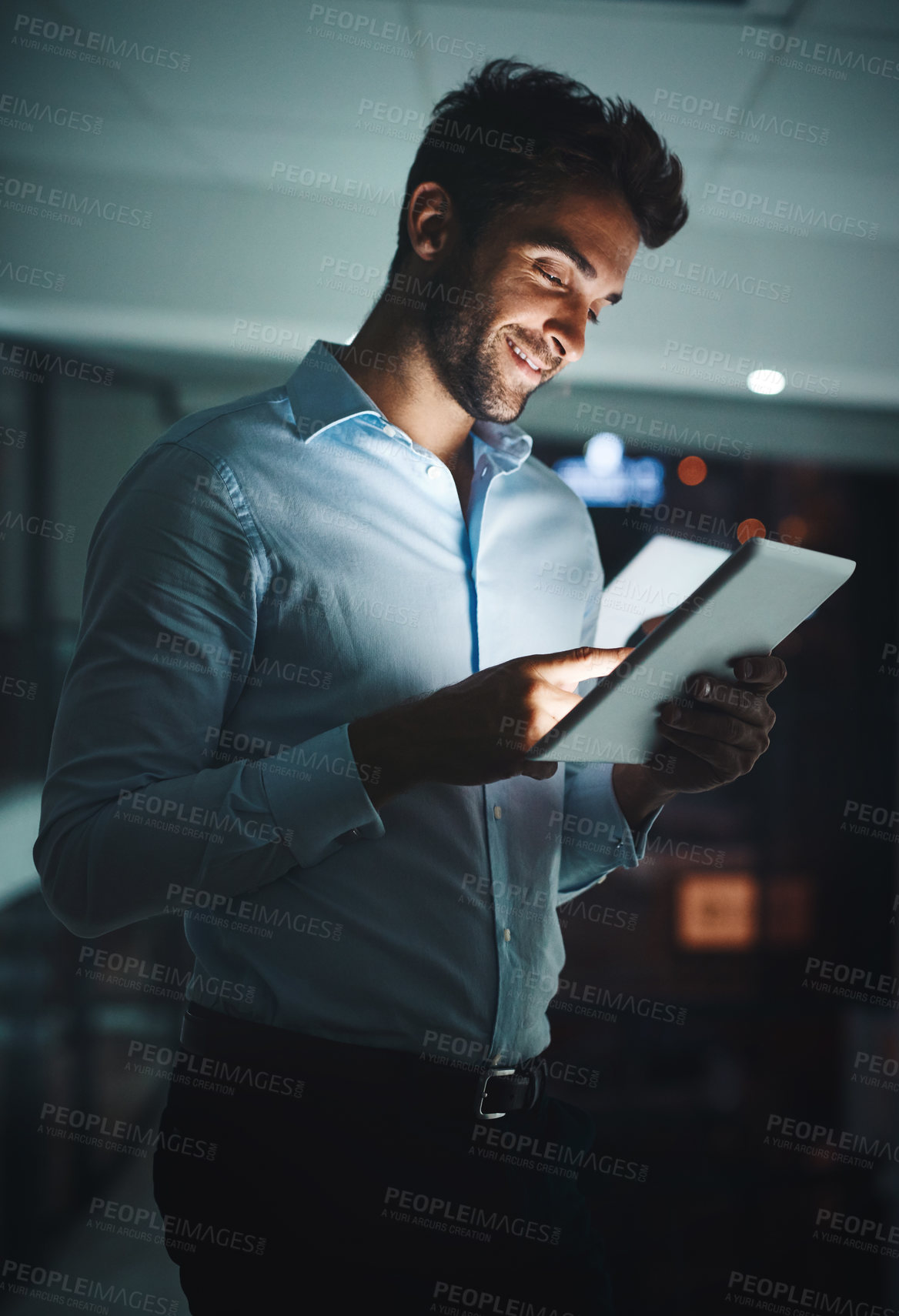 Buy stock photo Happy, businessman and night with tablet for research, networking or tech support at office. Young man, employee or IT specialist working late on technology for online maintenance at workplace