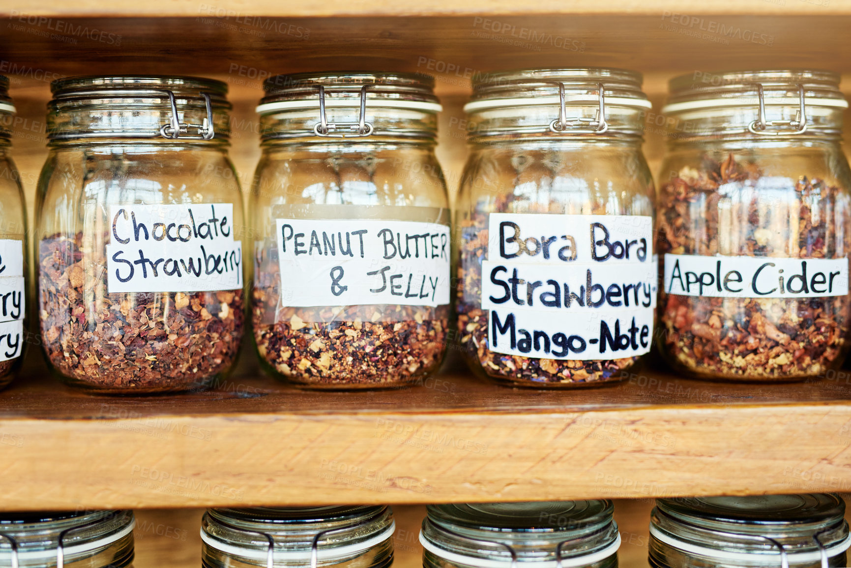 Buy stock photo Glass, tea jar and shelf at coffee shop for catering, flavor or organic leaves for drink in closeup. Container, antioxidant and natural herbs with stock, inventory or label for beverage at cafeteria