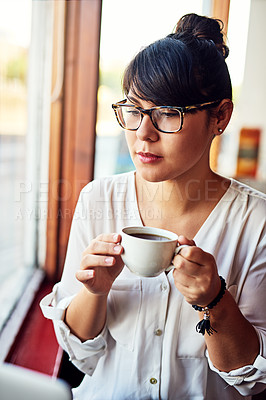 Buy stock photo Shot of a beautiful young woman drinking coffee at a cafe
