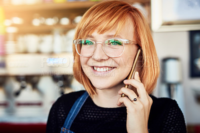 Buy stock photo Cropped shot of a shop assistant talking on her cellphone