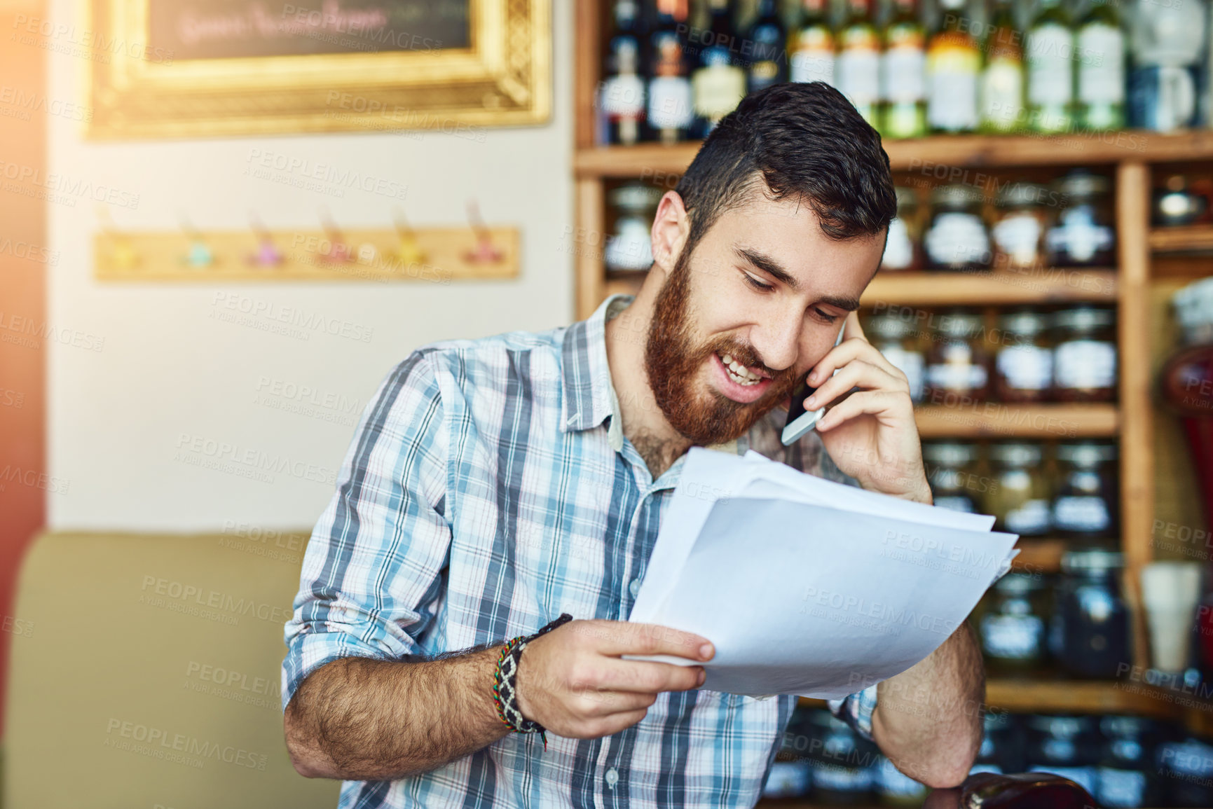 Buy stock photo Man, phone call and shop owner in restaurant with documents, thinking or negotiation for price, smile and deal. Barista, smartphone and paperwork for invoice, inventory and contact supplier in cafe