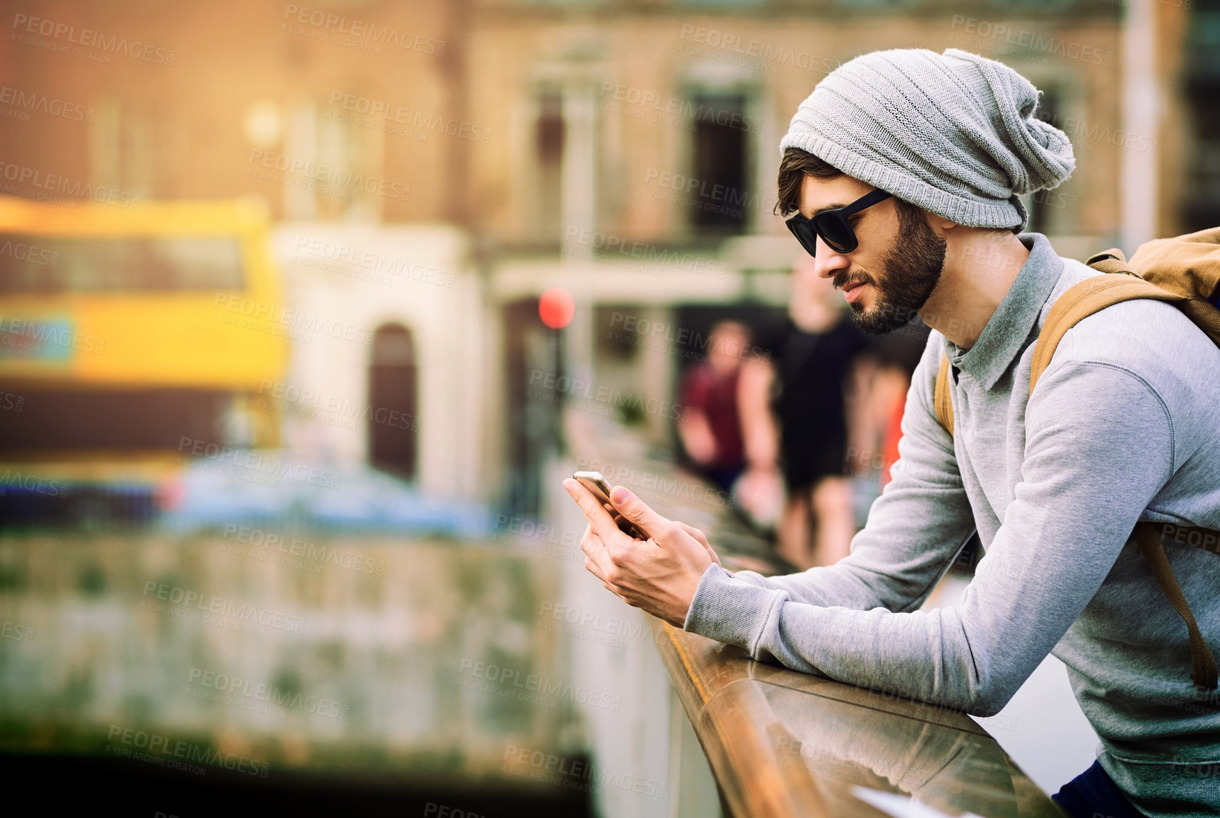 Buy stock photo Phone, internet and man with smile in city for journey, communication and search of location. Sunglasses, male person and technology with reading for outdoor travel, information and tourism in London