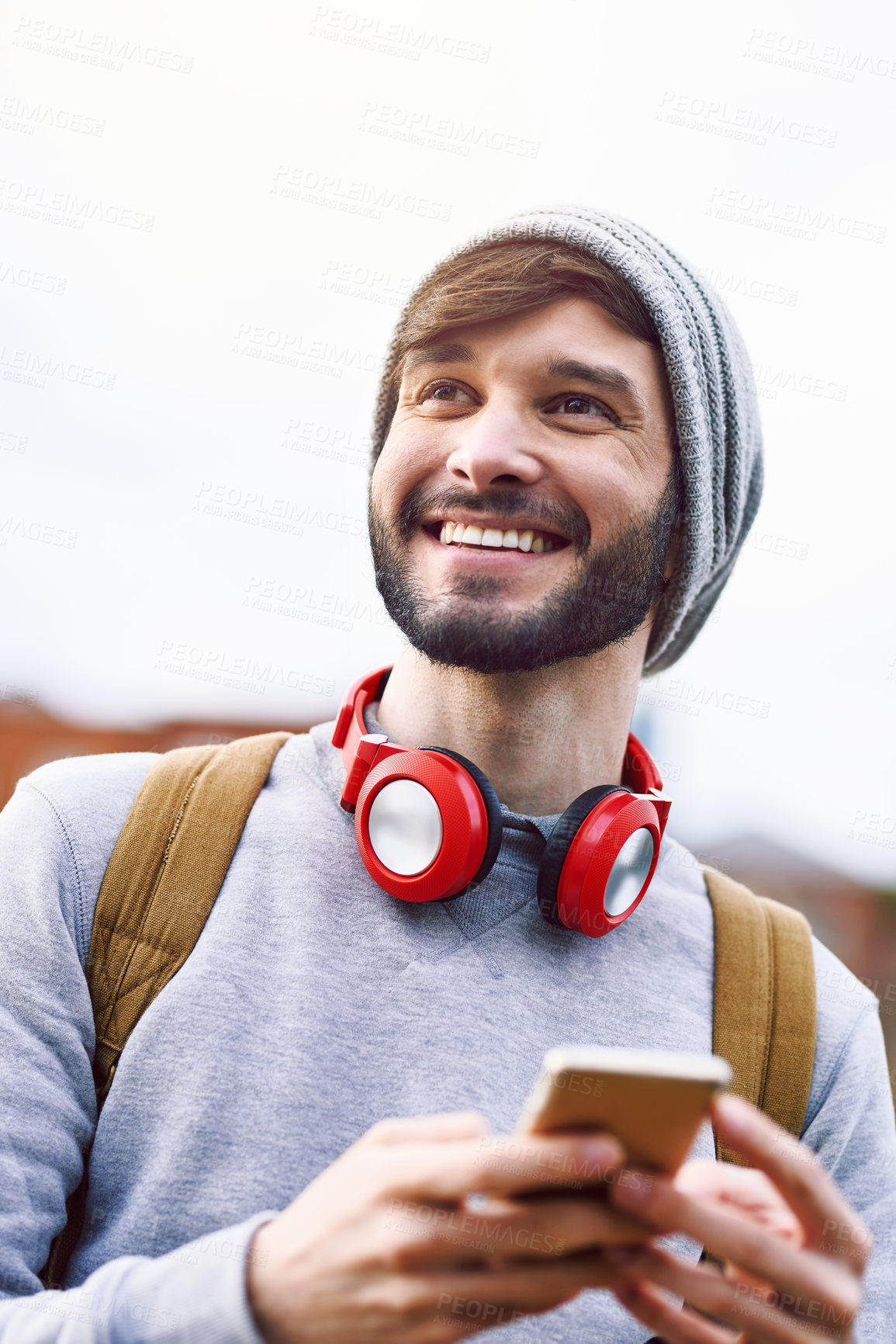 Buy stock photo Thinking, backpack and man with phone in city for travel, information and online navigation. Happy, male person and headphones with technology for outdoor journey, communication and tourism in London