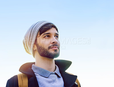 Buy stock photo Shot of a thoughtful young man standing outdoors