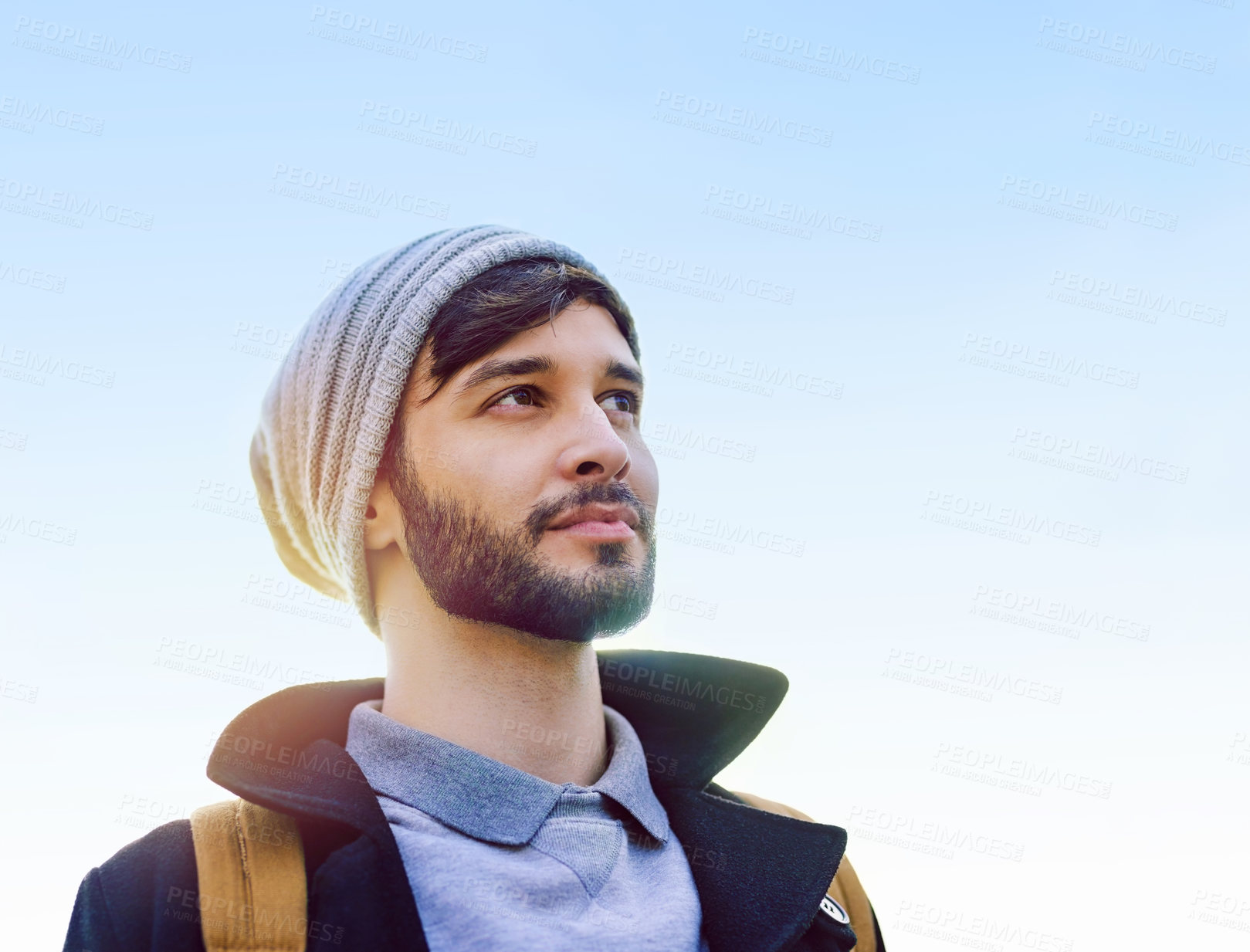 Buy stock photo Shot of a thoughtful young man standing outdoors