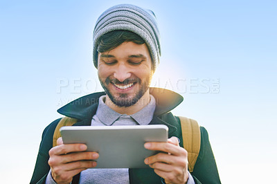 Buy stock photo Smile, student and man with tablet for social media, update and reading on internet outdoor. Comedy, happy and male person outside with technology for meme, communication and streaming on blue sky