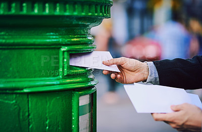 Buy stock photo Hands, mail and postbox with person in city, outdoor to send message via post office service closeup. Delivery, envelope or paper and business employee with postal letter on street of urban town