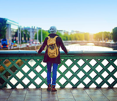 Buy stock photo Man, bridge and sightseeing in city for tourism, scenery and travel with backpack on fun holiday. Male person, back and explore of urban town for adventure, reflection and trip with view on vacation