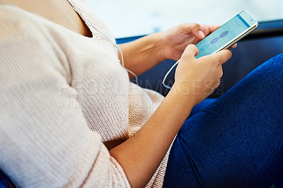 Buy stock photo High angle shot of an unrecognizable young woman using her smartphone while sitting on a bus