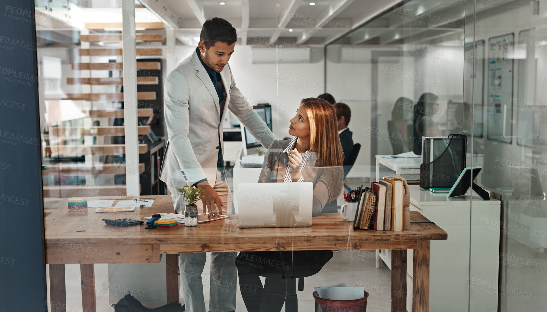 Buy stock photo Cropped shot of a young businessman helping an older female colleague in the office