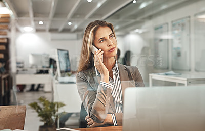 Buy stock photo Cropped shot of an attractive mature businesswoman making a phonecall while working in her office