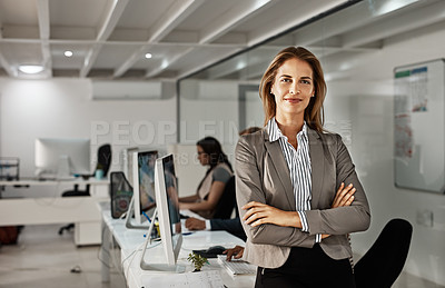 Buy stock photo Cropped portrait of an attractive mature businesswoman standing with her arms folded in the office