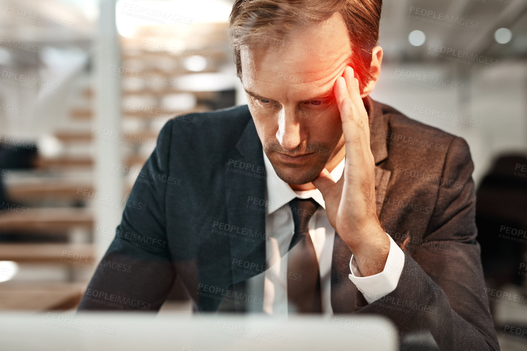 Buy stock photo Cropped shot of a handsome mature businessman suffering with a headache while working in his office