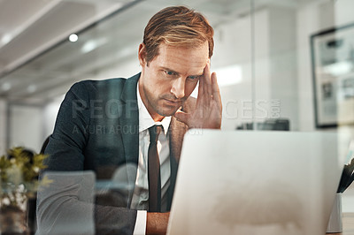 Buy stock photo Cropped shot of a handsome mature businessman suffering with a headache while working in his office