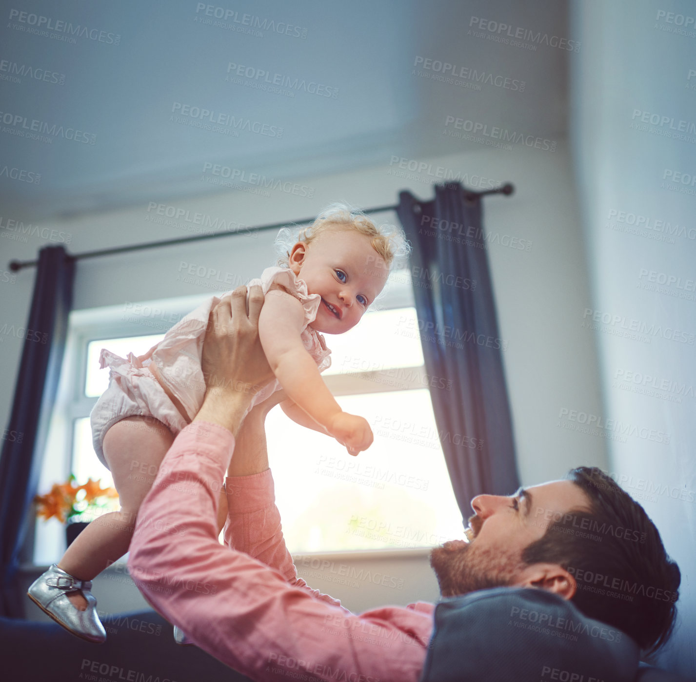 Buy stock photo Dad, baby and happy in air on living room sofa with love, playing and airplane game in family home. Care, support and infant girl smile in lounge together on weekend with fun, lifting and joy