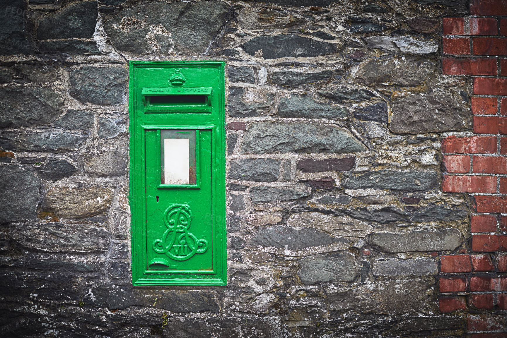 Buy stock photo Shot of a green letter box on a stone wall