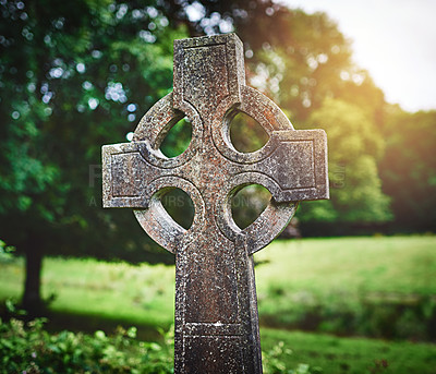 Buy stock photo Celtic cross, tombstone and graveyard for peace, memory and death outdoor. Christian crucifix, old gravestone or cemetery for catholic history, holy site or remembrance of religion in park in Ireland