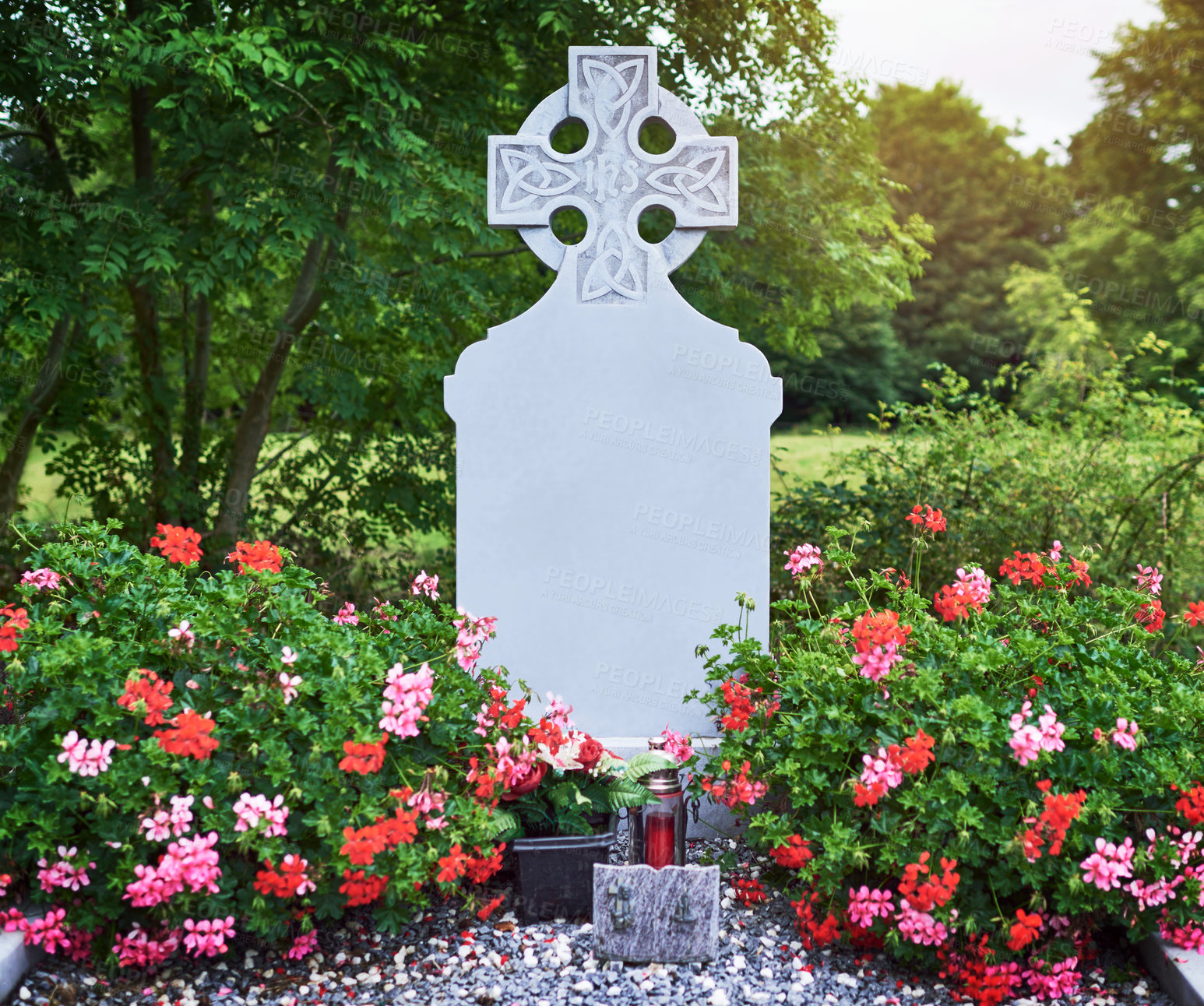 Buy stock photo Celtic cross, tombstone and graveyard with flowers for memory, peace or mockup space outdoor. Christian crucifix, blank gravestone or cemetery for catholic history, death or holy site for remembrance