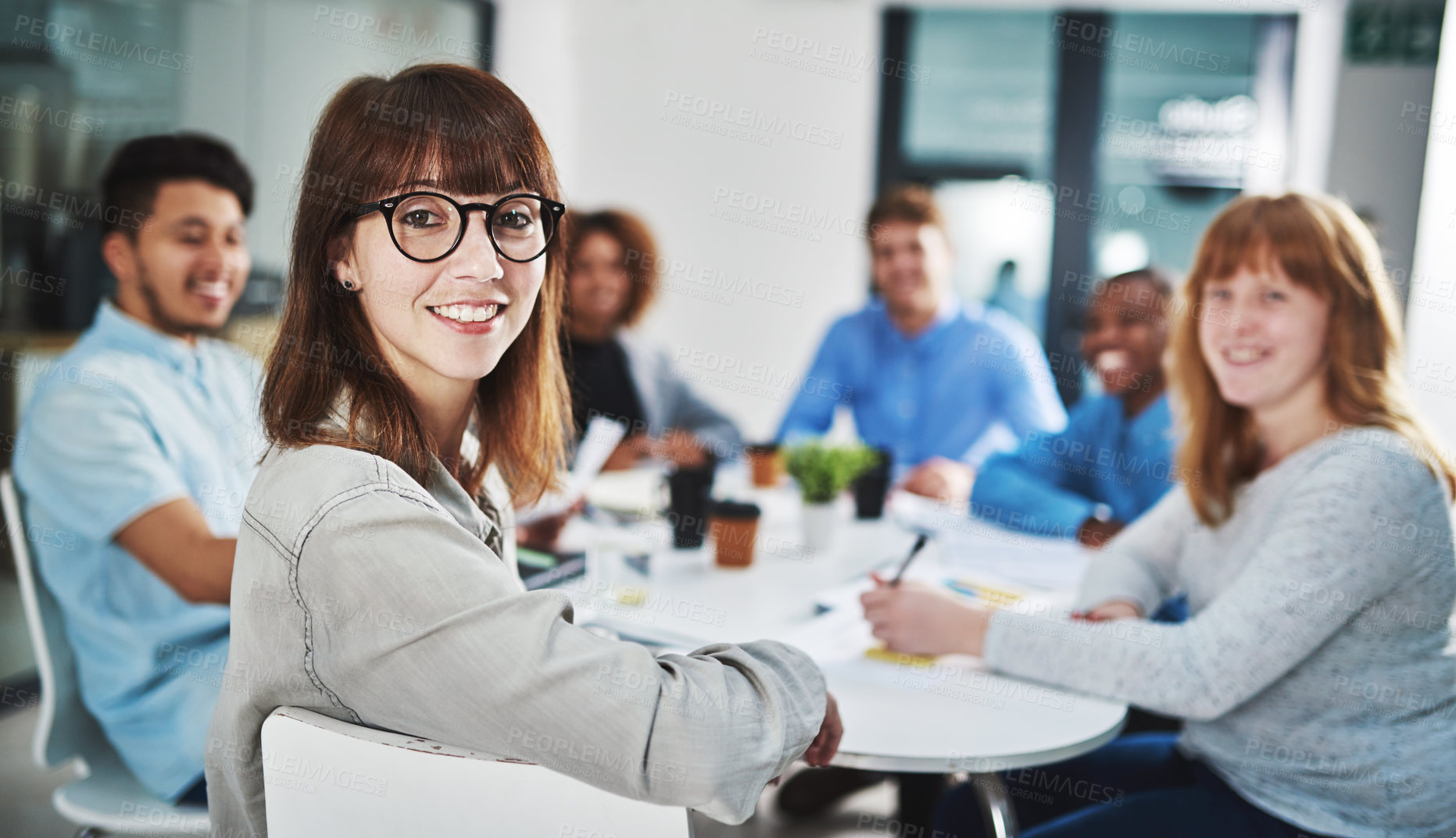 Buy stock photo Portrait of a young designer sitting in the boardroom with her colleagues