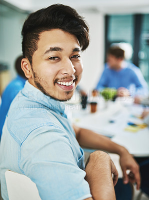 Buy stock photo Portrait of a young designer sitting in the boardroom with his colleagues