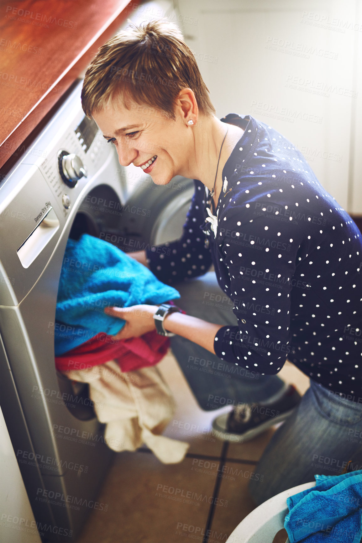 Buy stock photo Laundry, washing machine and woman in house sorting clean fabric, linen and fresh clothing. Lens flare, housework and female person with dryer for morning routine, chores and housekeeping task