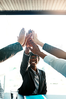 Buy stock photo Cropped shot of a group of businesspeople high-fiving in an office
