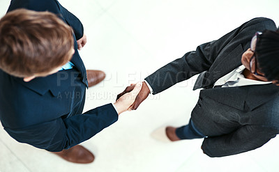 Buy stock photo Diversity, handshake and partnership with business people in office for agreement or deal from above. Meeting, thank you or welcome with man and woman employee shaking hands in workplace for contract
