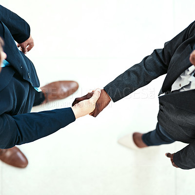 Buy stock photo Handshake, meeting and welcome with business people in office for agreement or deal from above. Corporate, b2b partnership or thank you with employee team shaking hands in workplace for contract