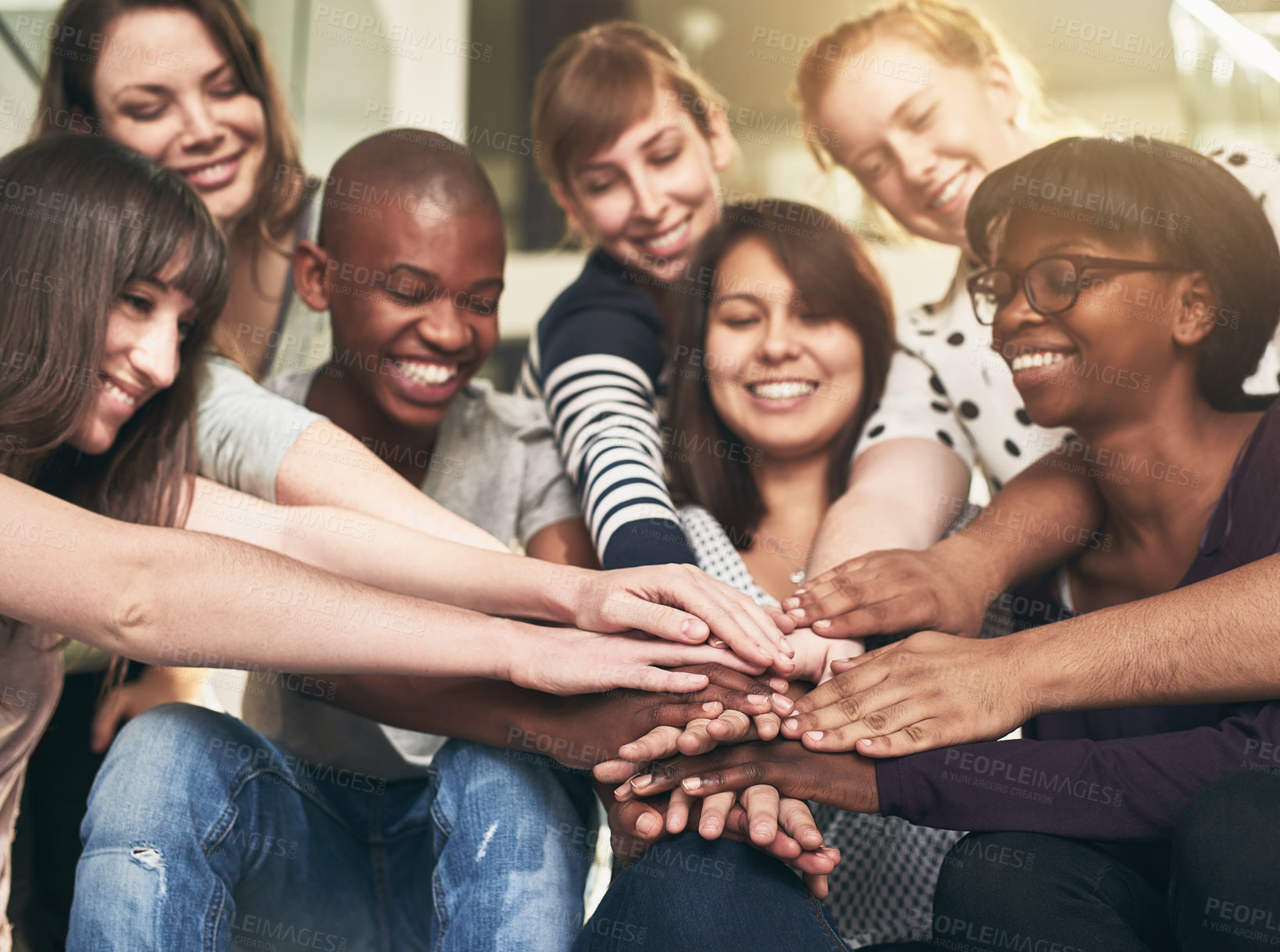 Buy stock photo Goal, motivation and friends with their hands in a huddle together for education, support or success. Teamwork, smile and trust with a happy group of students bonding at college or university