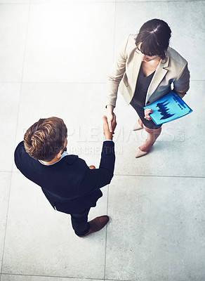 Buy stock photo Business people, handshake and partnership for b2b deal, agreement or collaboration in office. Above view, businessman and woman shaking hands in meeting for greeting, introduction or welcome