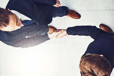 Buy stock photo Businessmen, handshake and partnership in meeting for b2b agreement, deal or collaboration with lens flare. Above view, professional and people shaking hands for greeting, introduction or welcome