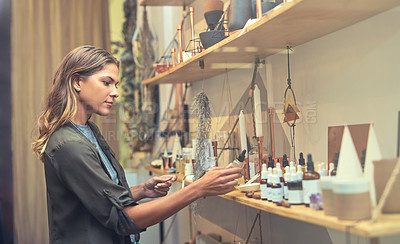 Buy stock photo Cropped shot of an attractive young woman looking at products in a store