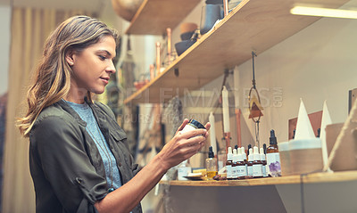 Buy stock photo Cropped shot of an attractive young woman looking at products in a store