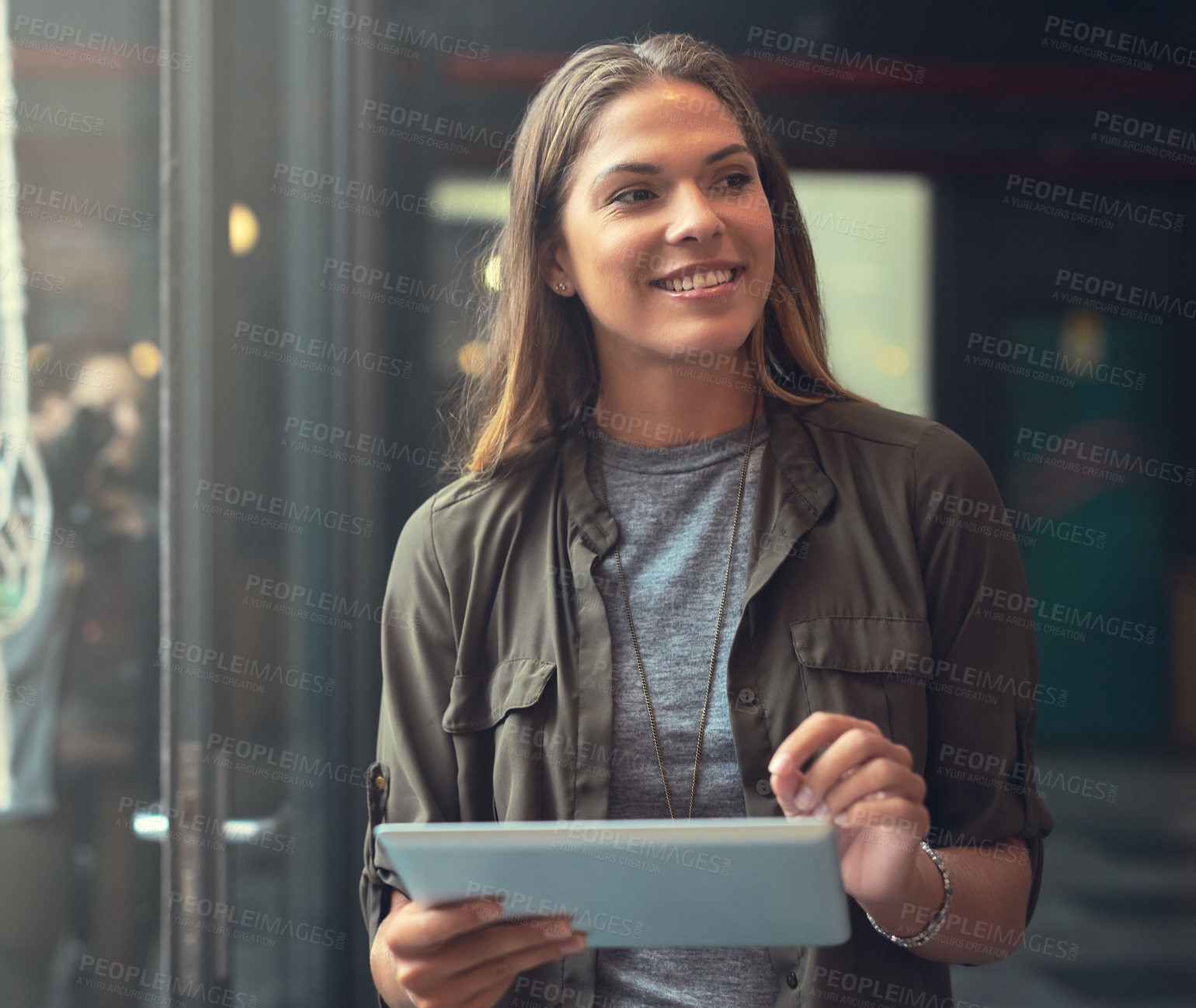 Buy stock photo Cropped shot of an attractive young female entrepreneur using a tablet in her store