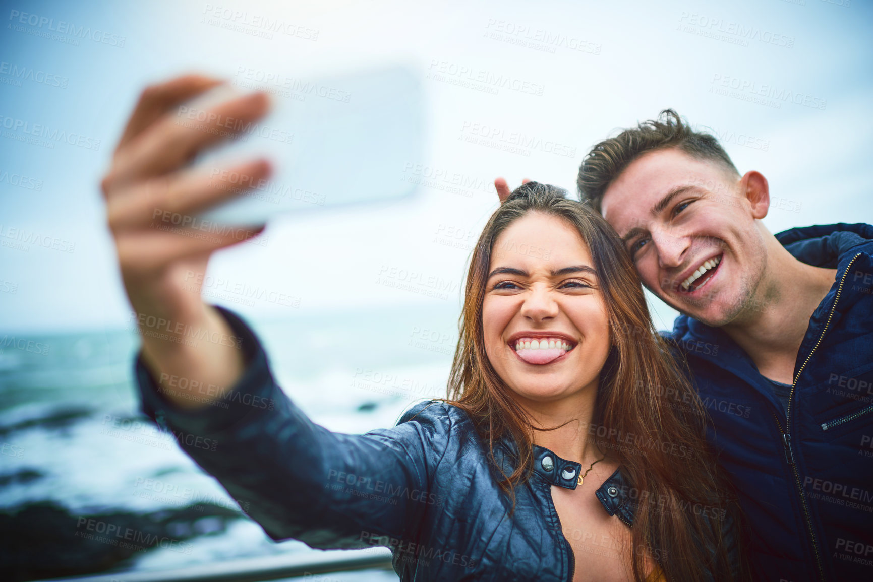 Buy stock photo Happy couple, beach and selfie with memory for photography, relationship or travel together in nature. Young, man and woman with smile for outdoor picture, moment or capture by ocean coast or sea