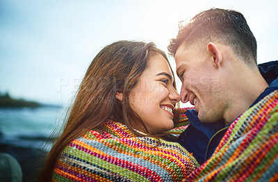 Buy stock photo Couple, happy and blanket by beach for love, bonding and relax with relationship, romance and date. Man, woman and smile outdoor for care, support and connection with partner, fun or weekend together