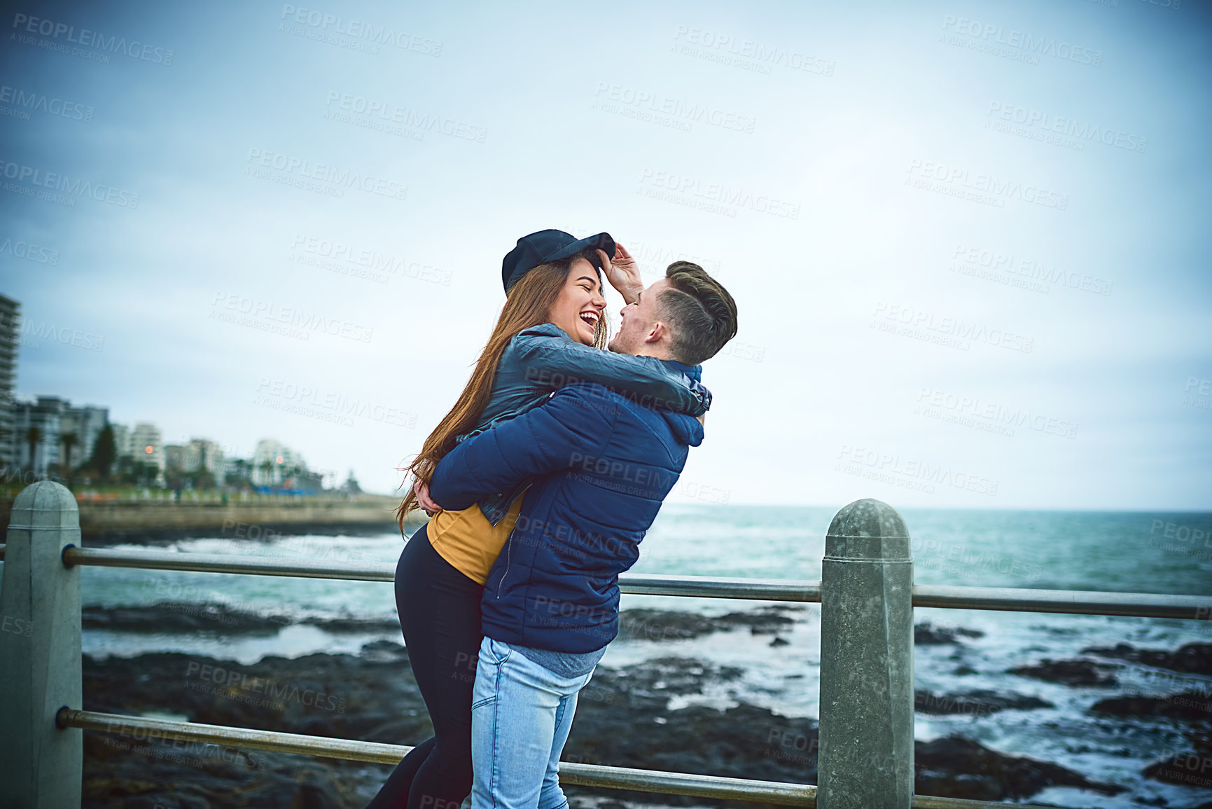 Buy stock photo Couple, hug and beach for love, bonding and relax with relationship, romance and outdoor date. Man, woman and happy by ocean for care, support and connection with partner, smile and weekend together