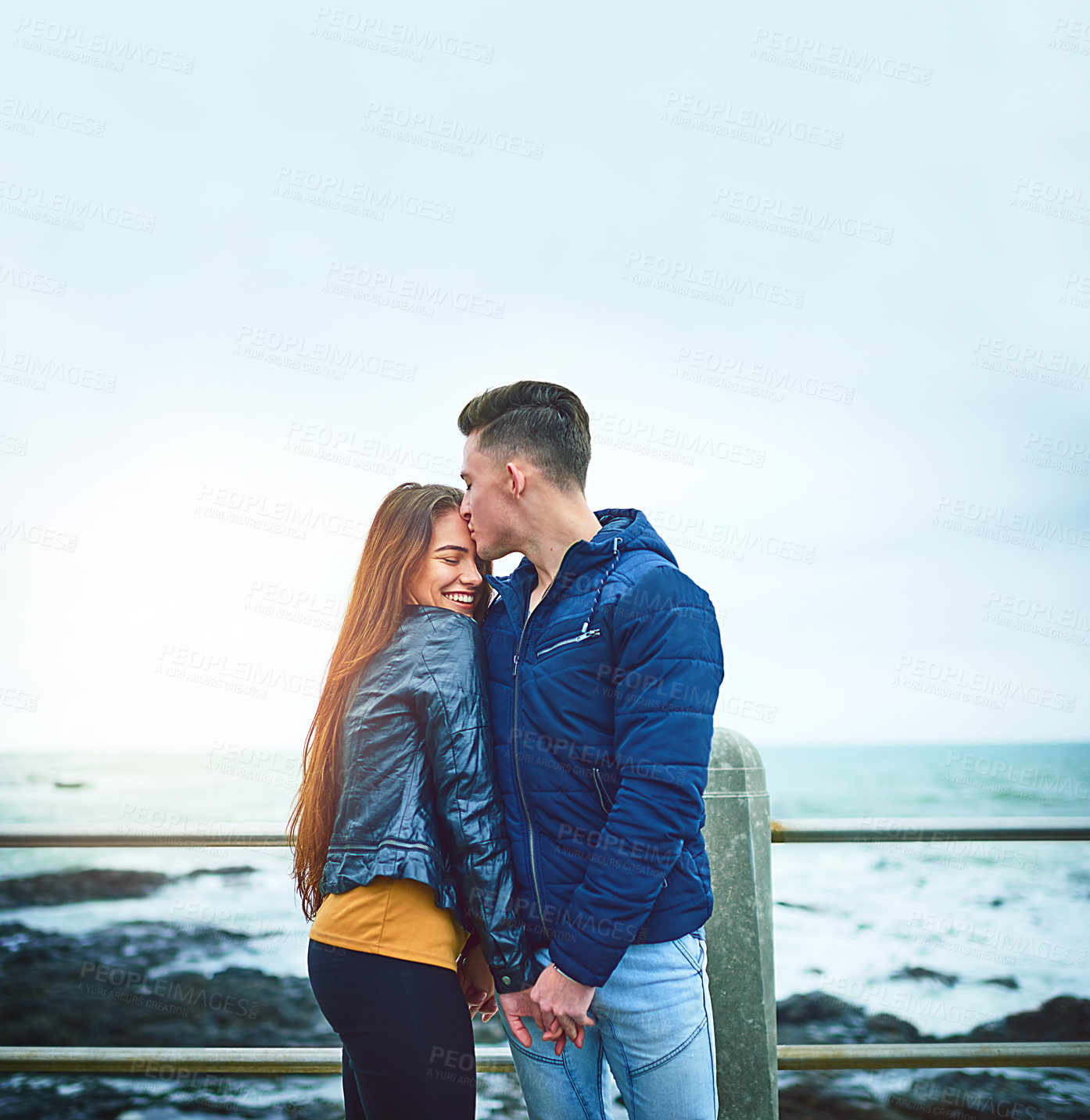 Buy stock photo Couple, happy and kiss by beach for love, bonding and relax with relationship, romance and date. Man, woman and ocean outside for care, support and connection with partner, fun and weekend together