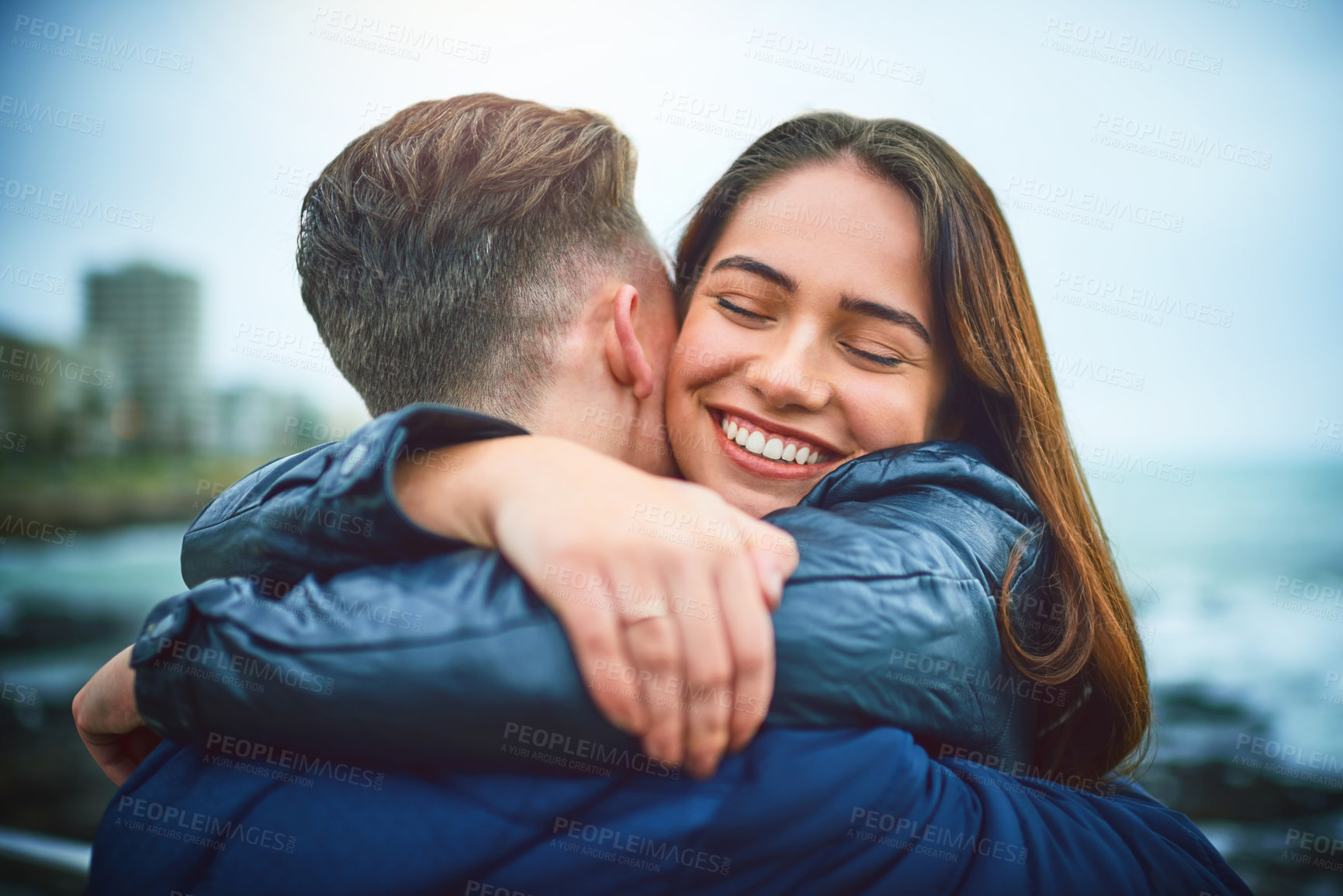 Buy stock photo Happy, couple and hug outdoor by sea with love, romance and date with smile and relax. Vacation, care and woman with embrace, bonding and break together on pier in Chicago on winter holiday by ocean