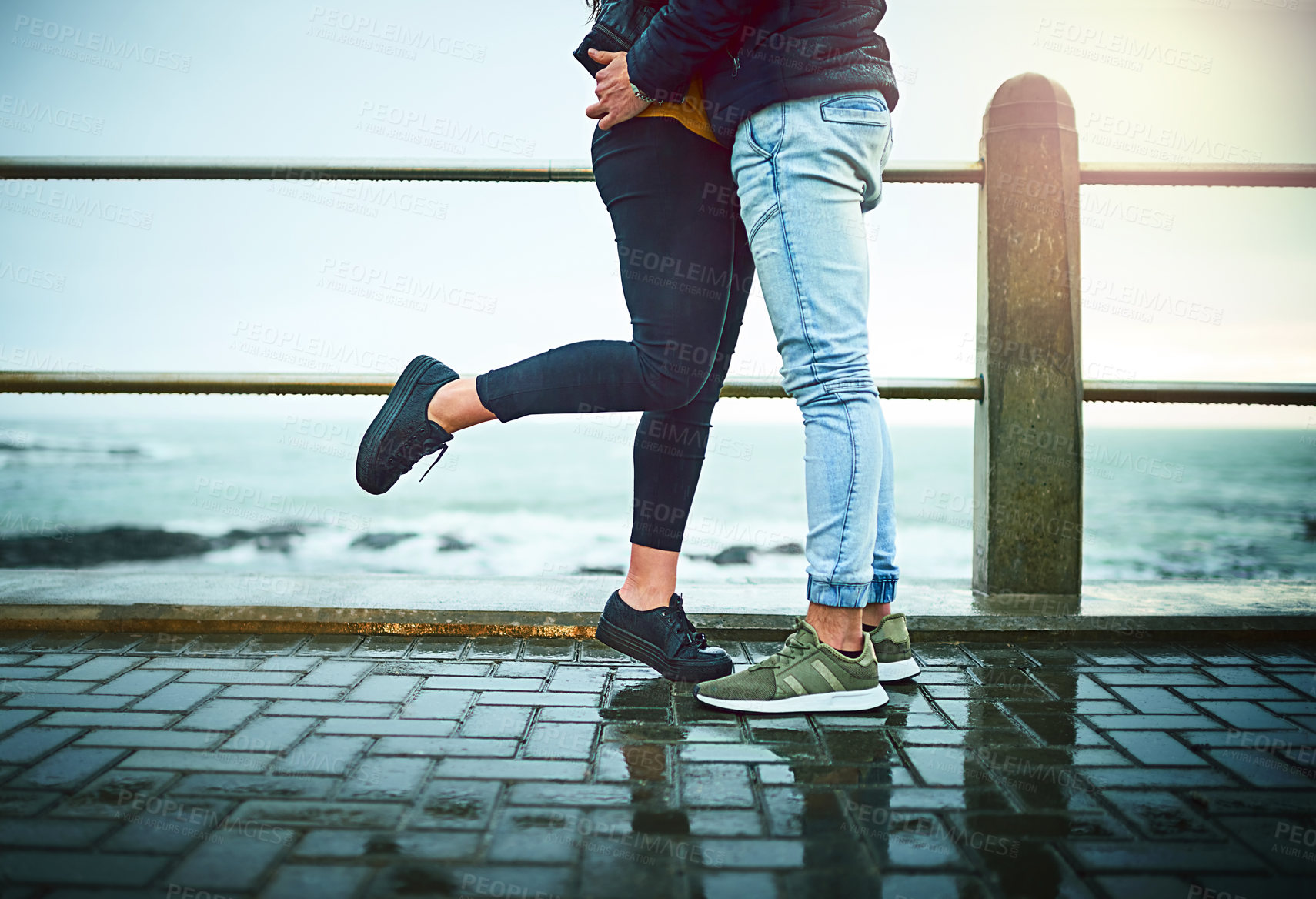 Buy stock photo Couple, legs and hug by beach for love, bonding and relax with relationship, romance and date. Man, woman and travel by ocean for care, support and connection with partner, break and weekend together