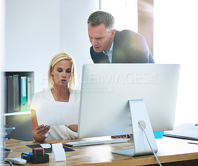 Buy stock photo Cropped shot of a mature businessman helping a younger female colleague in the office