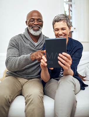 Buy stock photo Senior, couple and tablet on sofa together,  living room and browsing internet news or connection in apartment. Online, website and weekend or tech with interracial people, relationship and home