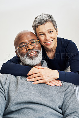 Buy stock photo Cropped portrait of an affectionate senior couple relaxing on the sofa at home