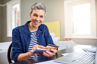 Buy stock photo Cropped portrait of a senior woman using her cellphone while working on her finances at home