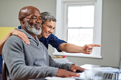 Buy stock photo Cropped shot of a senior couple working on their finances at home