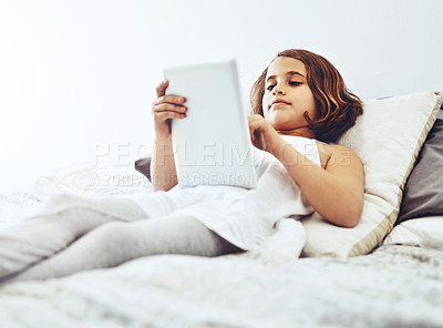Buy stock photo Home, lying and child on tablet in bed for game, relax and streaming cartoon or movies in bedroom. Happy girl, connection and tech in house for learning, education or reading ebook on app online