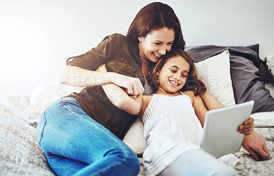 Buy stock photo Smile, mother and kid on tablet in bed at home together for game, bonding and family streaming movie. Happy girl, mom and technology in bedroom for learning, education or reading ebook on app online
