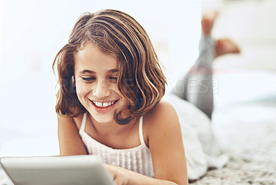 Buy stock photo Young girl, happiness and tablet in apartment for online streaming, games and watching videos. Connectivity, social media and kid at home for relax, holiday and reading stories on digital notebook